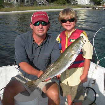 Young-man-catches-his-first-speckled-trout-in-Orange-Beach